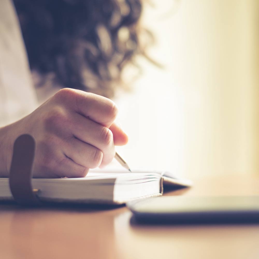 woman writing by hand
